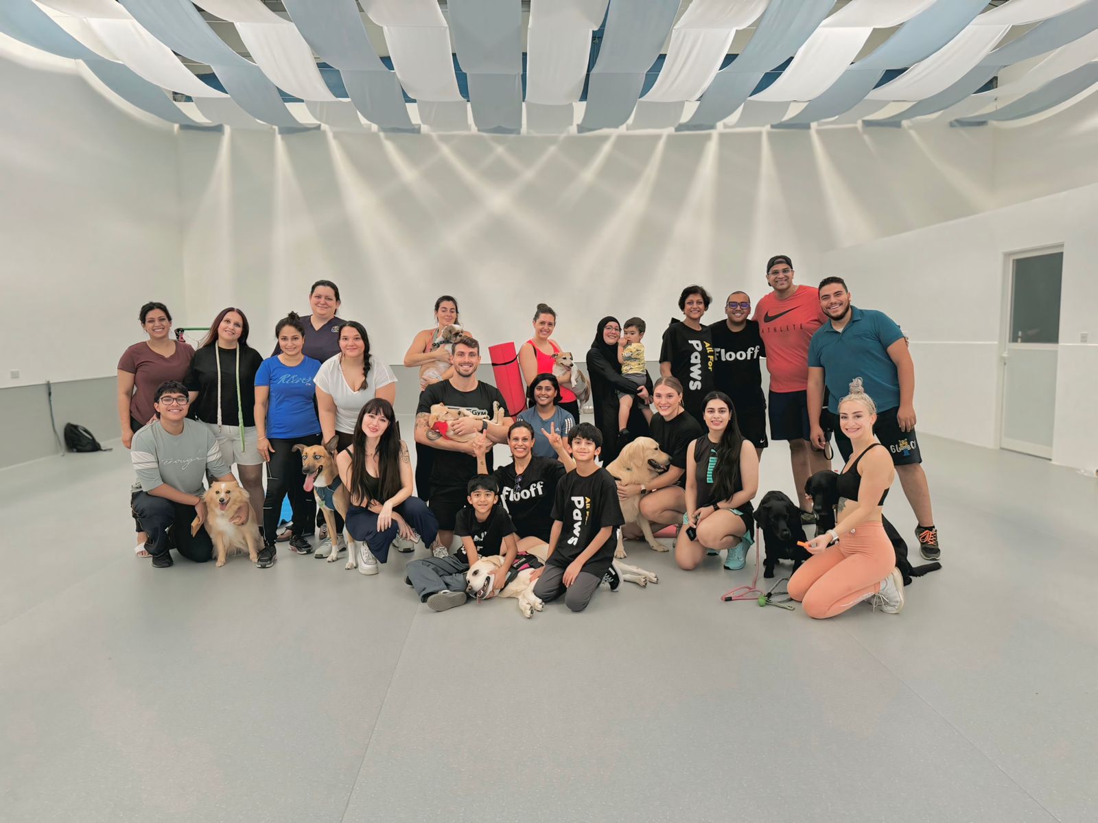 Large group of people and dogs in a group training class.